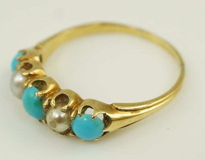 An early 20th century gold, three stone turquoise and two stone split pearl set half hoop ring